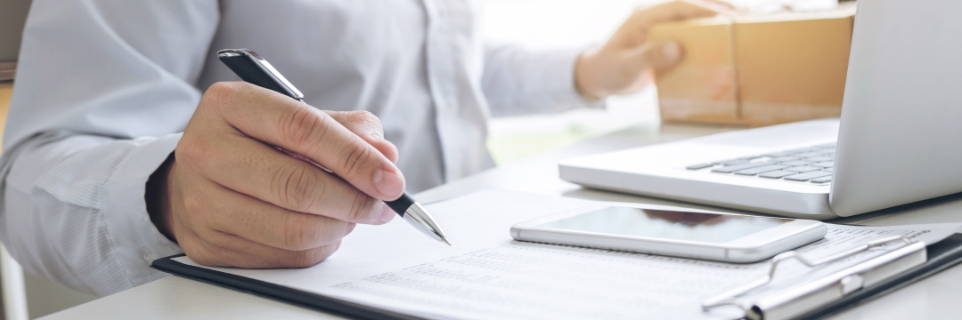 A man with a pen and papers