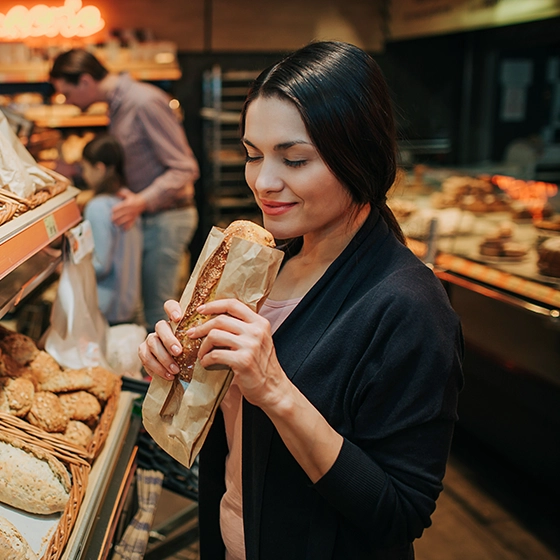 Eine Frau kauft frisches Brot