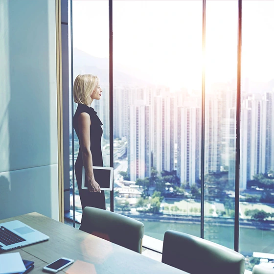 a woman in an office in front of the window