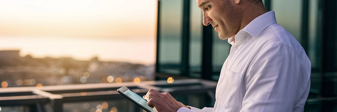 A man looks on a tablet