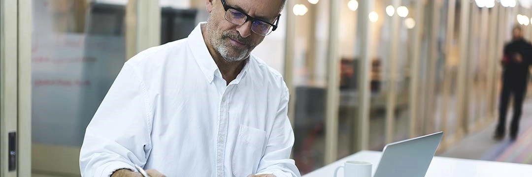 a man in front of a laptop