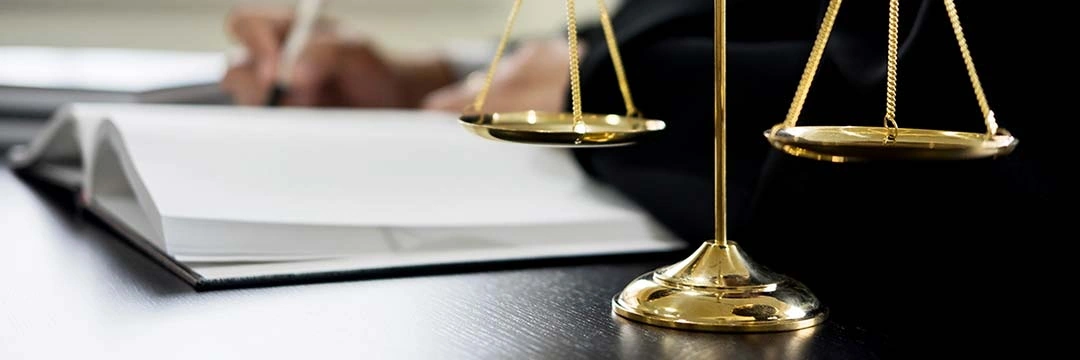 A golden scale on a desk