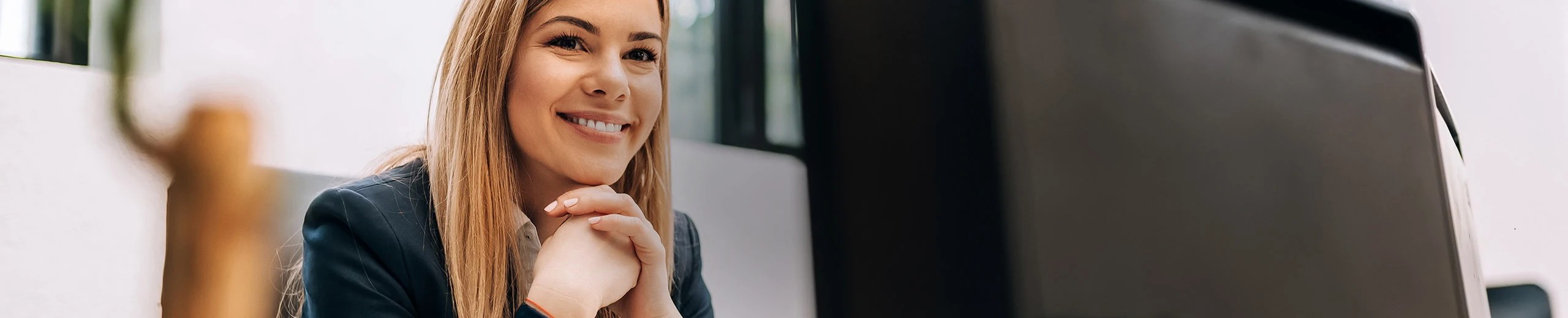 A woman sits in front of the computer