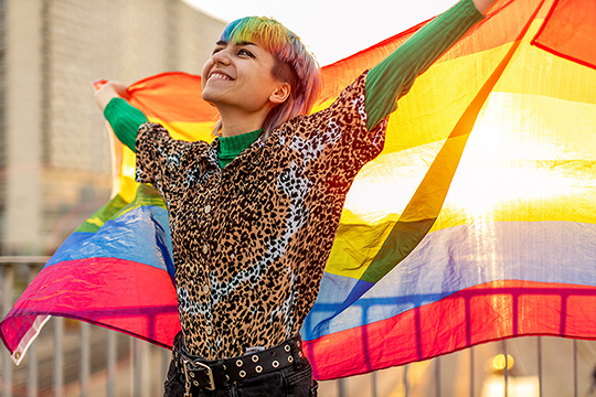 a woman holding a rainbow color