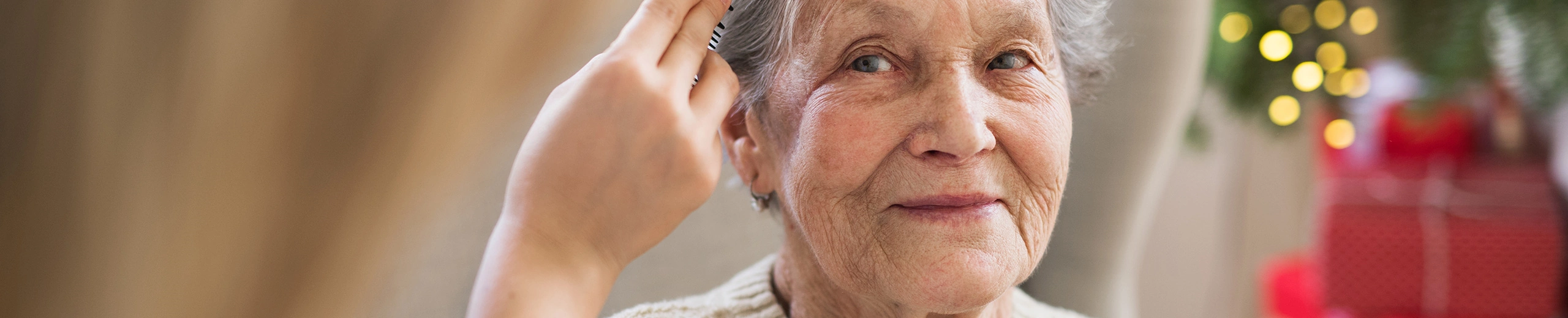 An old woman is being combed.