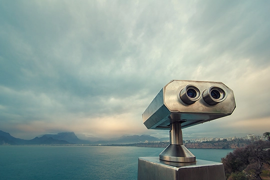 Binoculars pointed at the sea